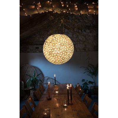 Unusual dining table lighting. Large oyster shell ceiling pendant light suspended over long wooden dining table