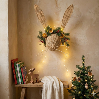 Decorative wall piece with rabbit ears and Christmas decorations in a cozy room.