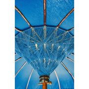 Macro shot of the handwoven blue threadwork at the center of the parasol, revealing Balinese craftsmanship.