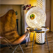 Sculpture white table lamp and tall white floor lamp in living room. Shell lighting by Collectiviste UK.