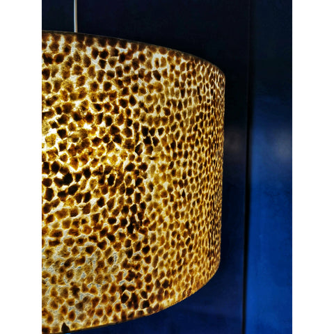 Close up of large gold hanging lamp. Callisto by Collectiviste.