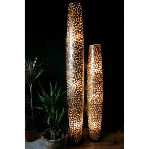 Tall gold floor lamp made from mother of pearl. Natural lighting by Collectiviste.