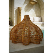Scalloped lamp shade woven from natural rattan in Moroccan villa. Lacey by Collectiviste.