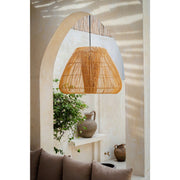 Modern rattan lamp shade hanging in alcove of Mediterranean villa. Rattan lighting by Collectiviste.
