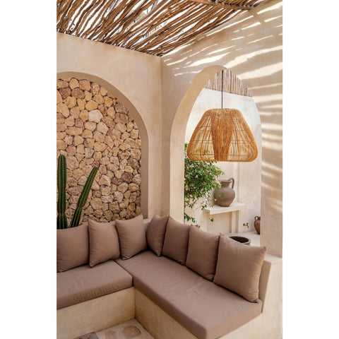 Outdoor living area shaded with coffee wood. Holkham large rattan lamp shade by Collectiviste lighting UK.