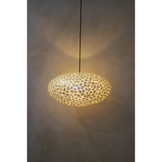 Oval light shade crafted from mother of pearl. Safari by Collectiviste.