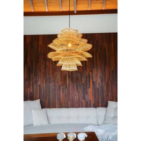 Unique rattan ceiling pendant in living room with beige sofa and wooden walls.