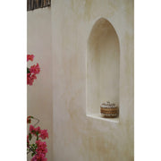 Small round jewellery box made from bamboo and decorated with cowrie shells in villa archway.