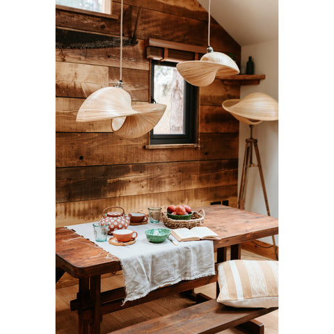 Traditional log cabin interior design. Bamboo lighting and ochre cushion by Collectiviste.