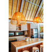 Modern rattan lamp shades hanging over marble kitchen island. Holkham lighting collection by Collectiviste UK.