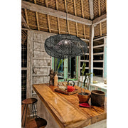 Contemporary joglo kitchen with wooden island, rattan roof and large black rattan lamp shade by Collectiviste lighting.